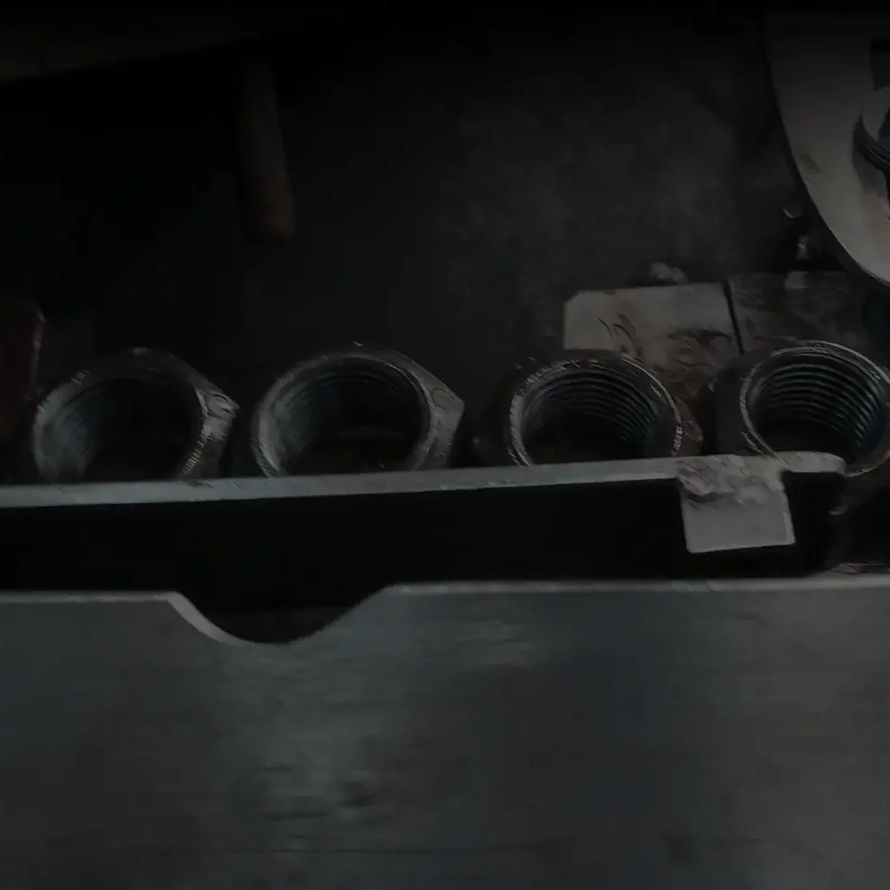 Industrial metal locknuts arranged in rows on a surface.